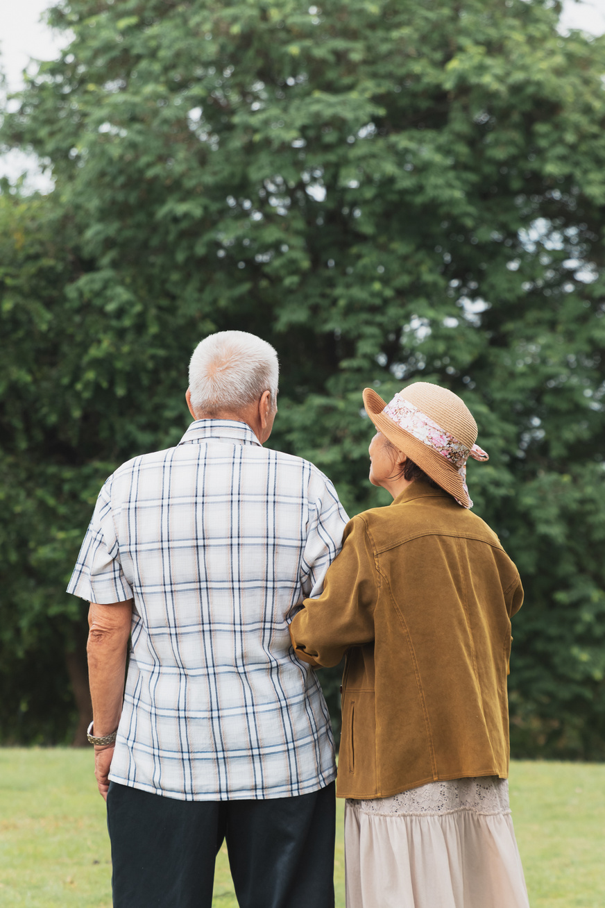 Elderly Couple Linking Arms at the Park